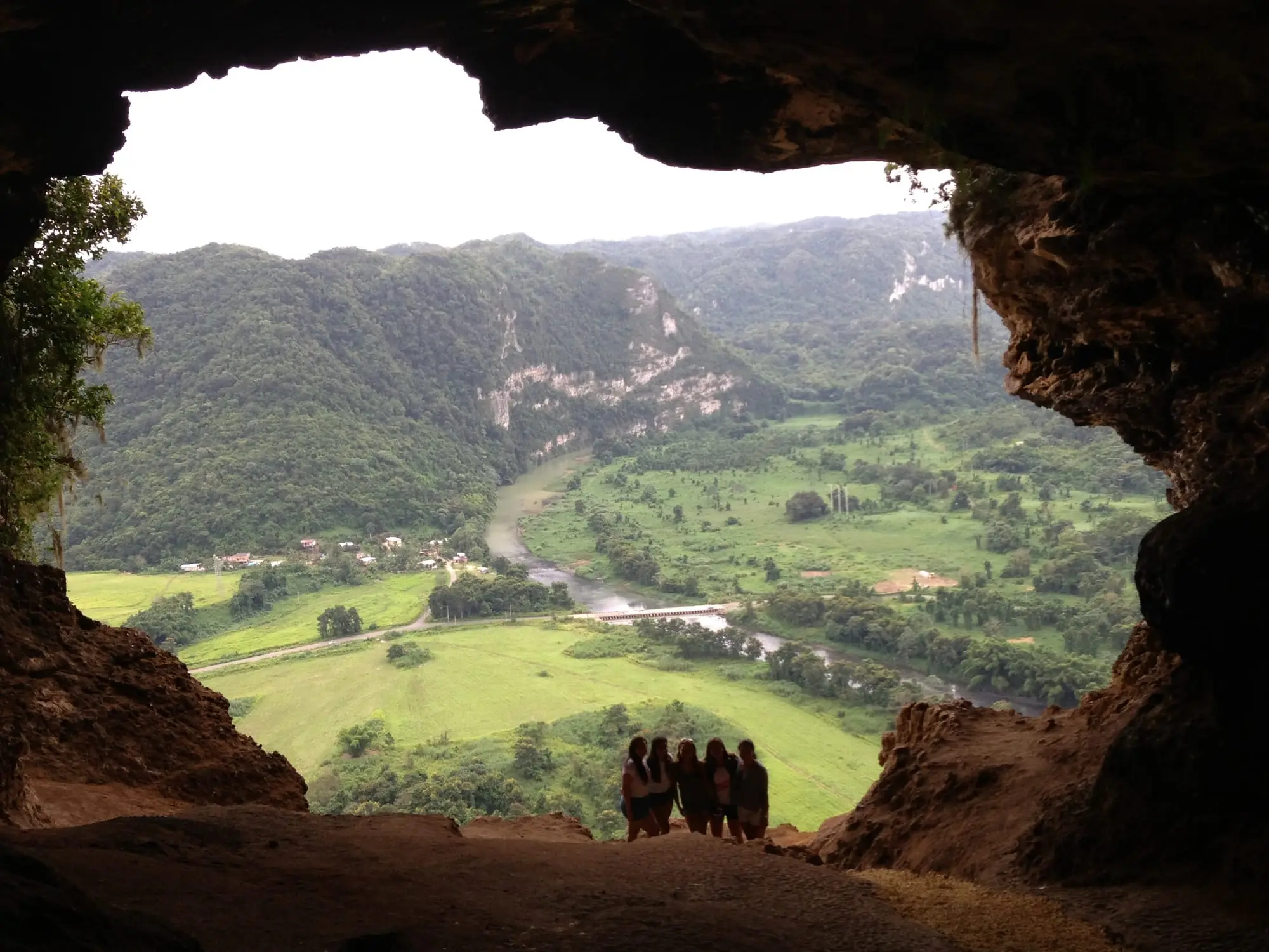 View from inside Cueva Ventana: the cave mouth frames the green Río Grande de Arecibo valley and its limestone hills