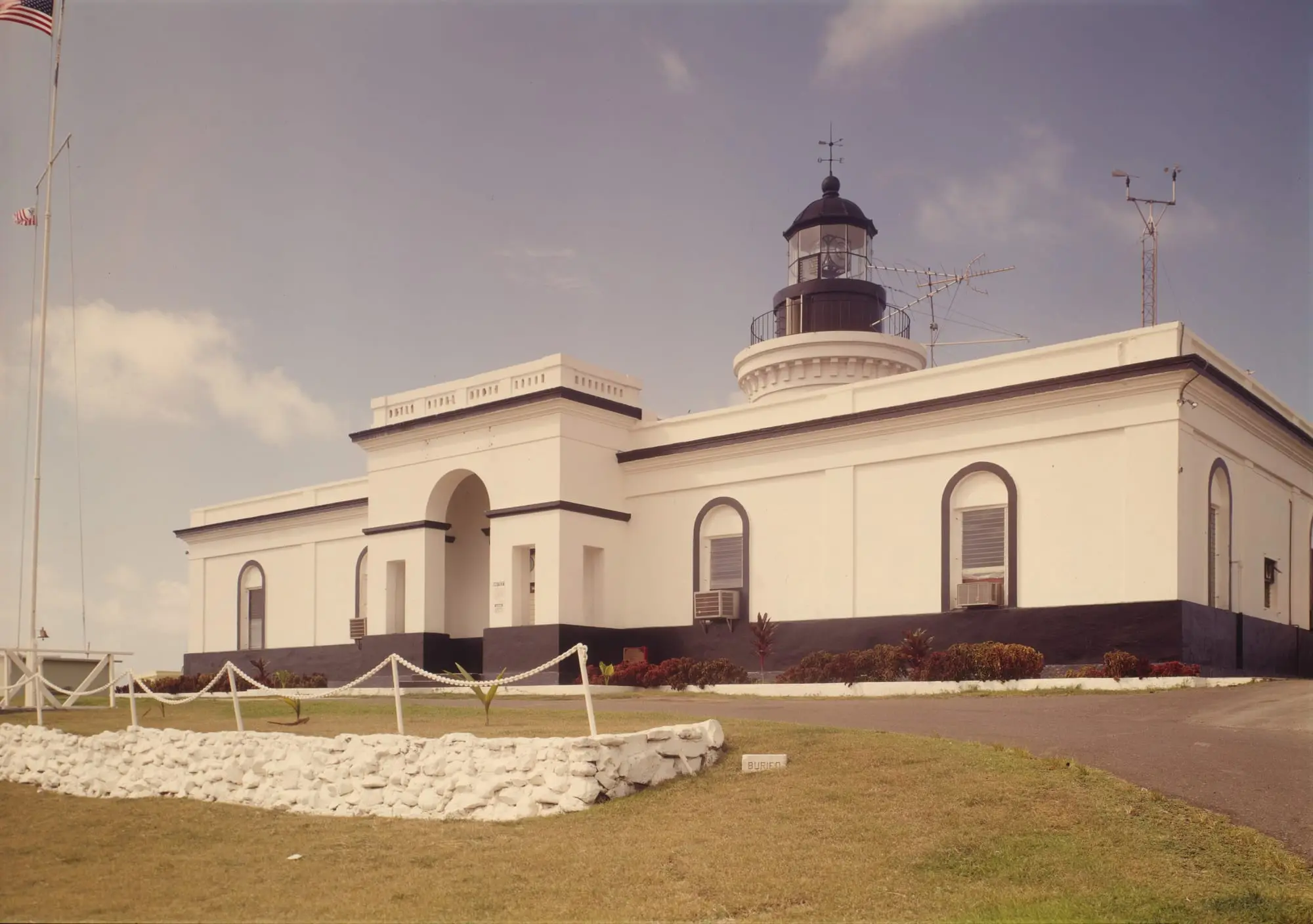 The white neoclassical lighthouse of Las Cabezas de San Juan, with its black lantern, on the headland of Fajardo