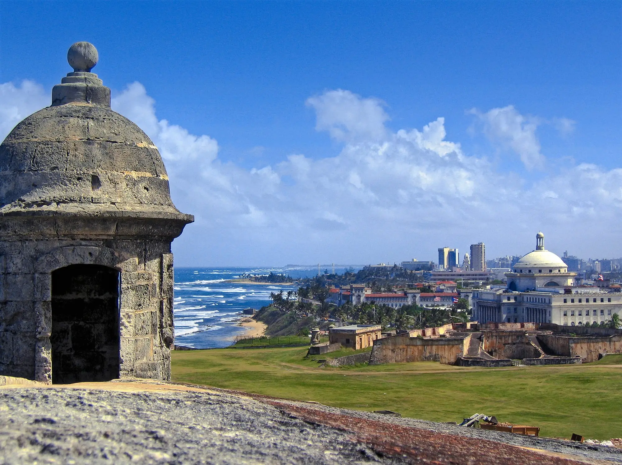 A stone sentry box on the walls of Castillo San Cristóbal, overlooking the ocean and the Capitol of Puerto Rico