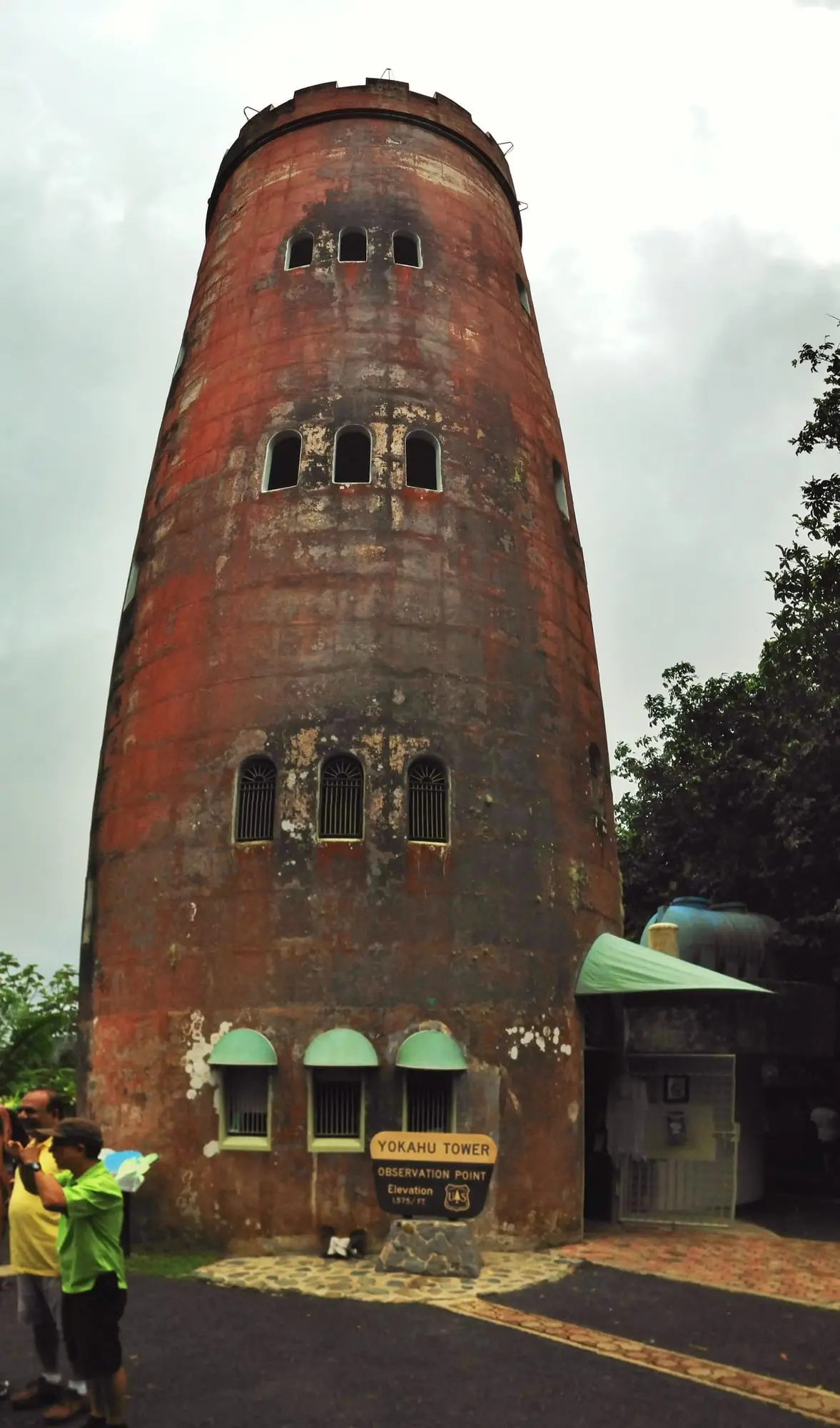 The round stone Yokahú observation tower in El Yunque, with its small arched windows, among rainforest trees